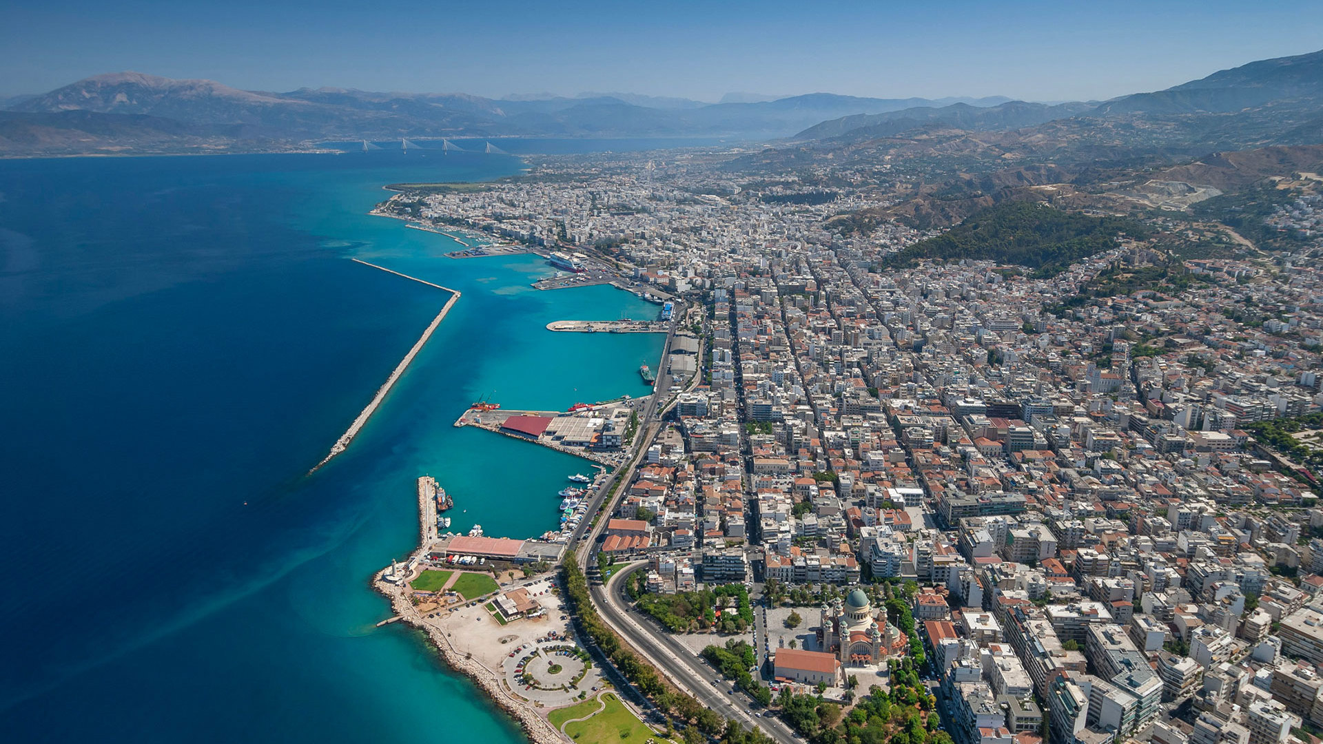 Patras from above, with the seafront, the long harbour breakwater and the city spreading towards the hills